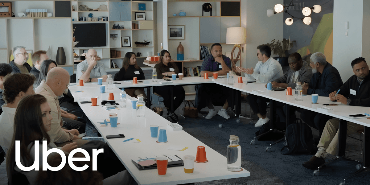 A diverse group of people participating in a meeting around a long table